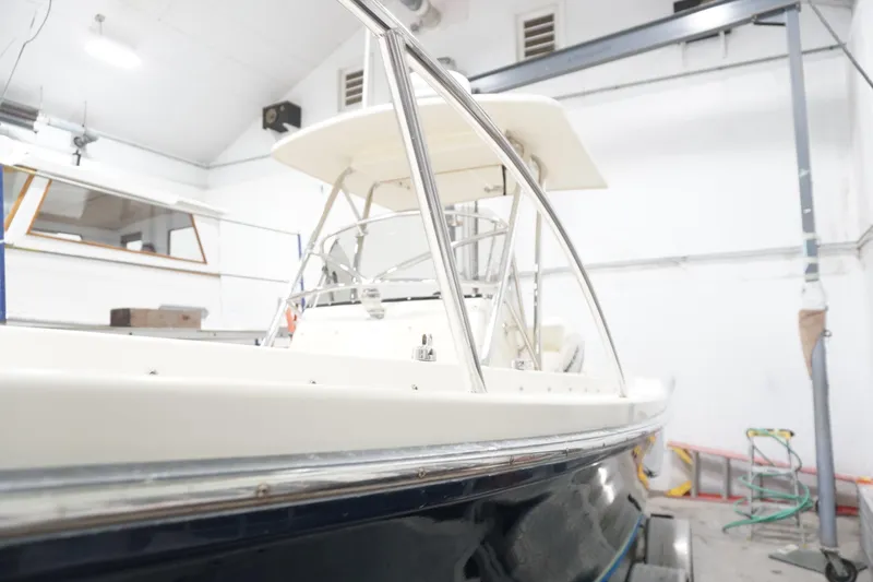 Slide: The Image of 2003 Padebco 23 boat in a workshop, showcasing sleek design and sturdy construction. - 14