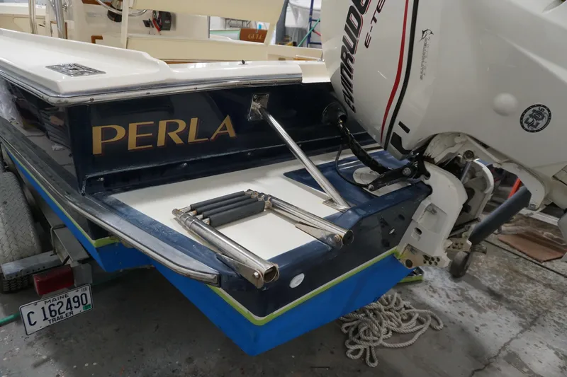 Slide: The Image of 2003 Padebco 23 boat named "Perla" with Evinrude engine on trailer. - 22