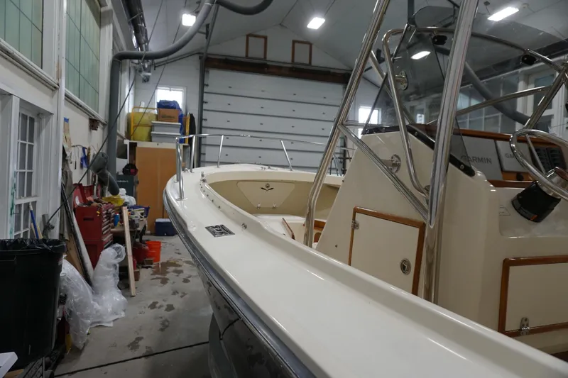 Slide: The Image of 2003 Padebco 23 boat in a workshop, showcasing its sleek design and modern equipment. - 25