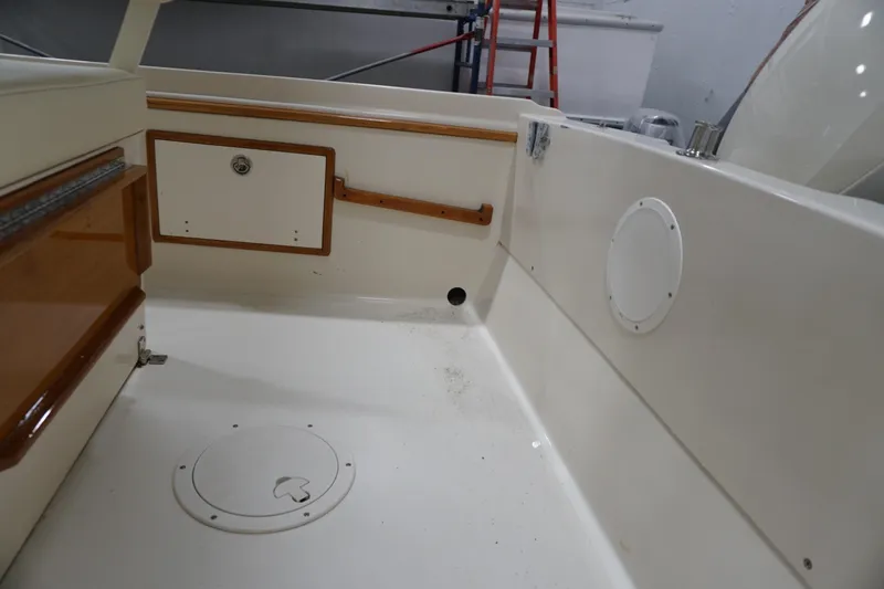 Slide: The Image of 2003 Padebco 23 boat interior with storage compartments and clean white deck. - 26