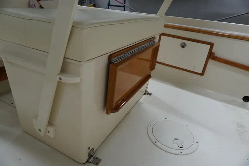 Slide: The Image of 2003 Padebco 23 boat interior with cushioned seating and wooden accents. - 27