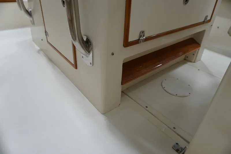 Slide: The Image of 2003 Padebco 23 boat interior with storage compartment and wooden accents. - 28