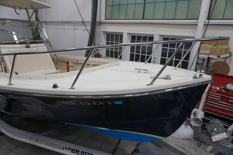 Slide: The Image of 2003 Padebco 23 boat in a workshop, featuring a sleek design and sturdy railings. - 3