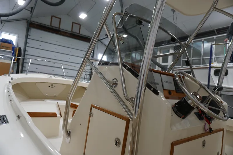 Slide: The Image of 2003 Padebco 23 boat interior with steering wheel and navigation equipment in a garage. - 30