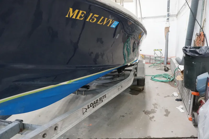 Slide: The Image of 2003 Padebco 23 boat on Load Rite trailer in garage setting. - 36