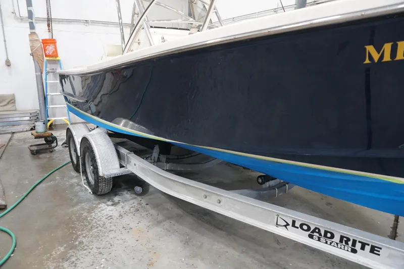Slide: The Image of 2003 Padebco 23 boat on Load Rite trailer in a garage setting. - 37