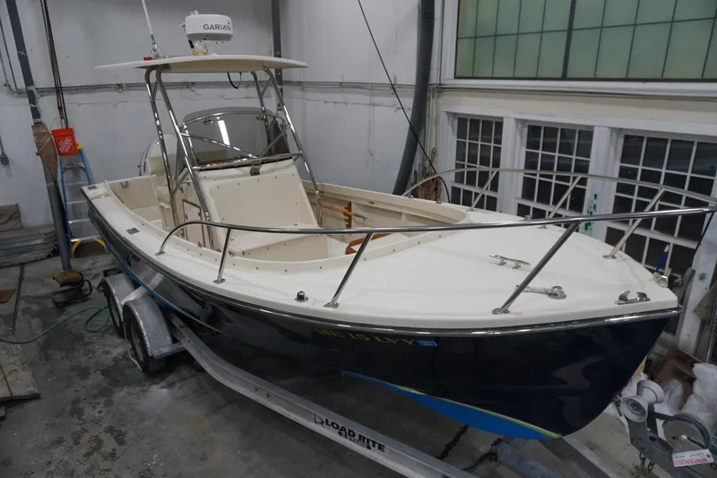 Slide: The Image of 2003 Padebco 23 boat in a garage, on a trailer, with Garmin equipment. - 4