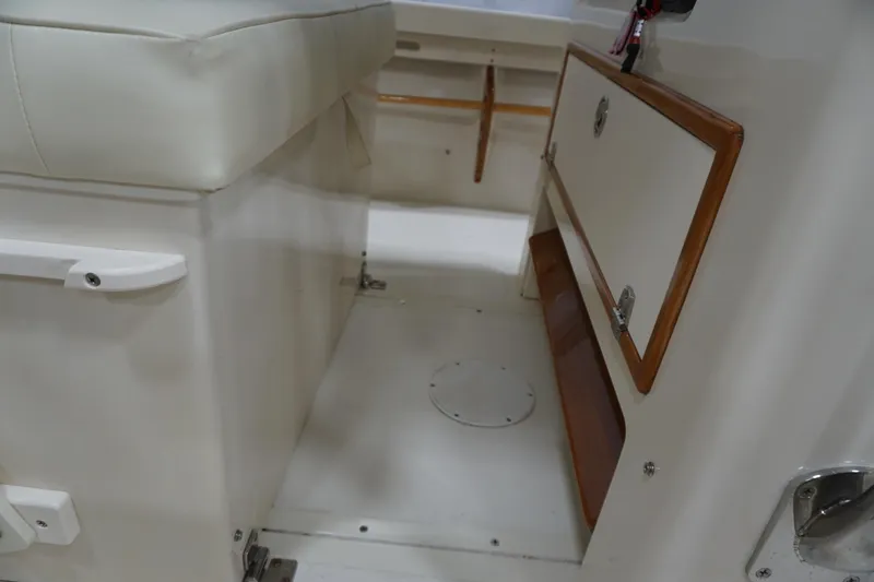 Slide: The Image of Interior of a 2003 Padebco 23 boat, featuring seating and storage compartments. - 41