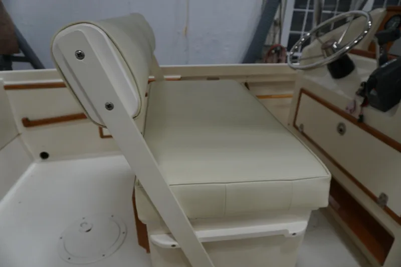 Slide: The Image of 2003 Padebco 23 boat interior with cushioned seating and steering wheel. - 9