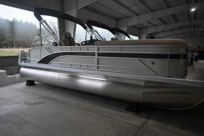 Slide: The Image of 2026 Bennington S Swingback 22 SSB pontoon boat in a covered storage area. - 0
