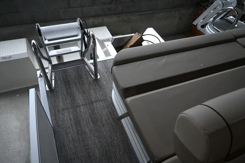 Slide: The Image of 2026 Bennington S Swingback 22 SSB interior with seating and ladder detail. - 11
