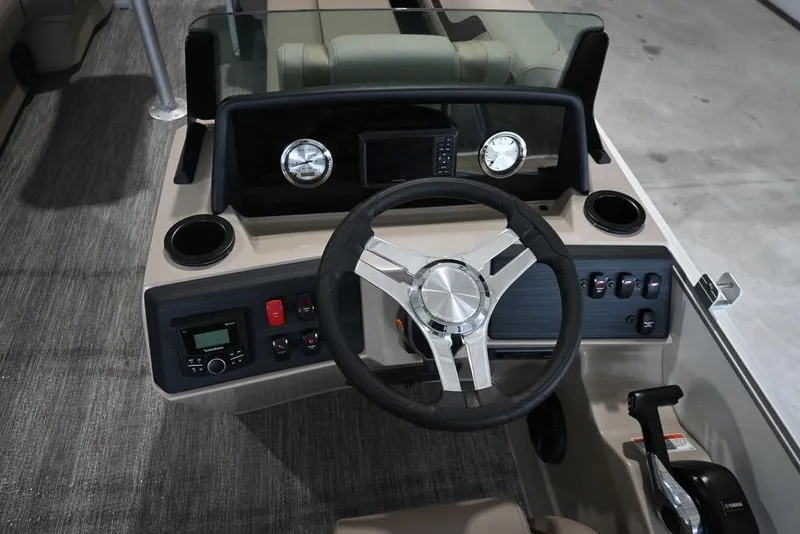 Slide: The Image of 2026 Bennington S Swingback 22 SSB boat dashboard with steering wheel and controls. - 13