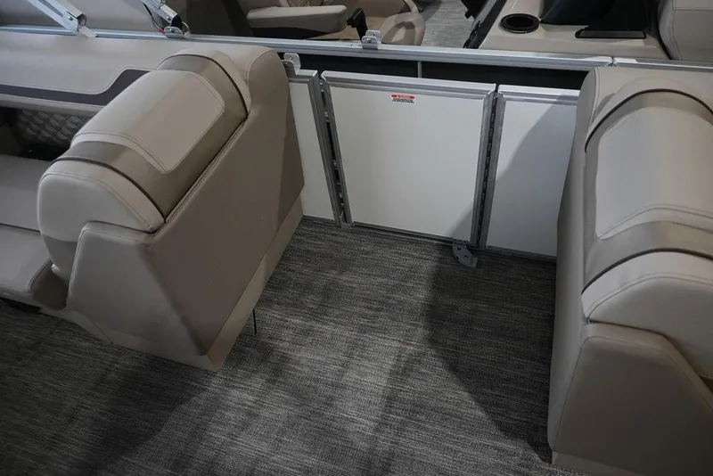 Slide: The Image of 2026 Bennington S Swingback 22 SSB interior with beige seating and carpeted flooring. - 14