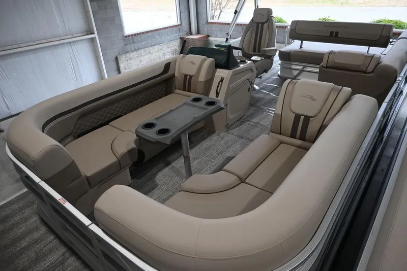 Slide: The Image of 2026 Bennington S Swingback 22 SSB pontoon boat interior with luxurious seating and table. - 9