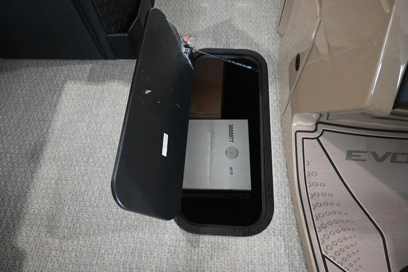 Slide: The Image of Open storage compartment in 2026 Evotti 723CS, revealing a box inside. - 16