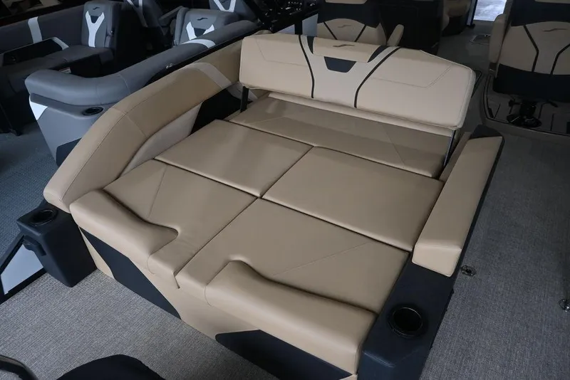 Slide: The Image of Luxurious seating in the 2026 Evotti 723CS boat, featuring beige upholstery and cup holders. - 18