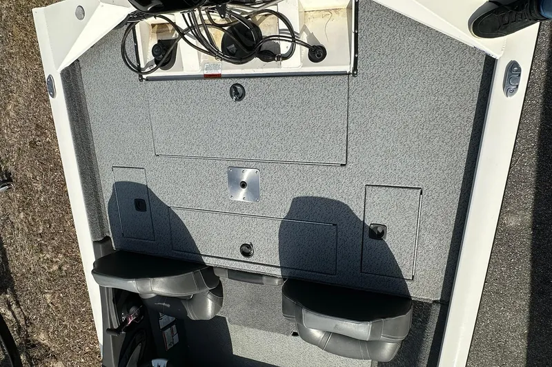 Slide: The Image of 2019 Tracker Pro Team 175 TXW boat interior with storage compartments and seating. - 14