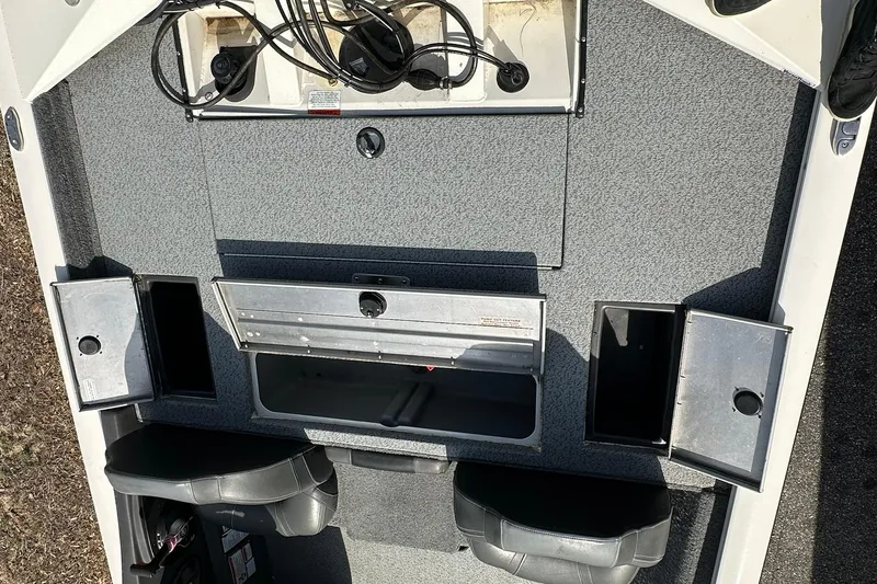 Slide: The Image of 2019 Tracker Pro Team 175 TXW boat interior with storage compartments and seating. - 15