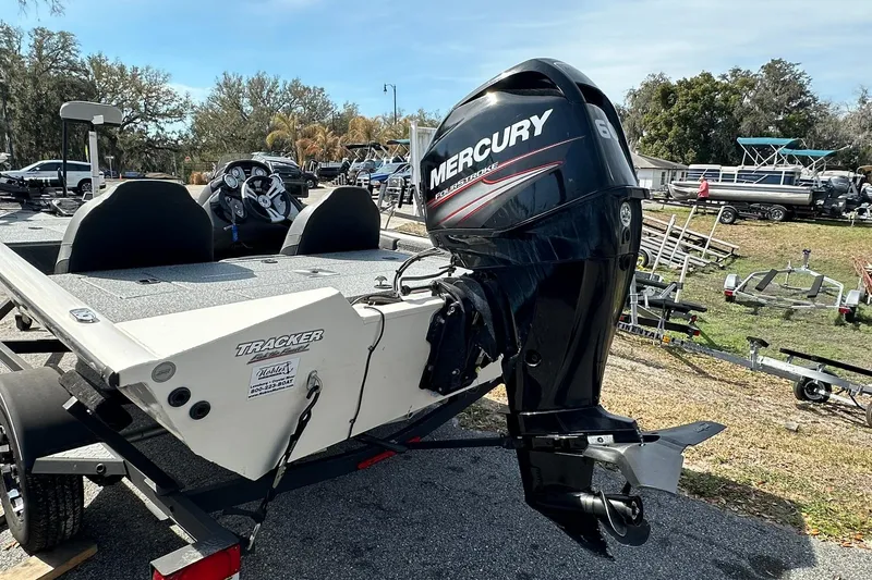 Slide: The Image of 2019 Tracker Pro Team 175 TXW boat with Mercury outboard motor in a parking area. - 17