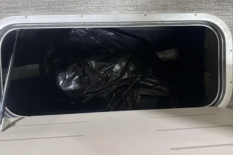 Slide: The Image of Storage compartment in 2026 Bennington 25 QXSBWASF boat with black bag inside. - 10