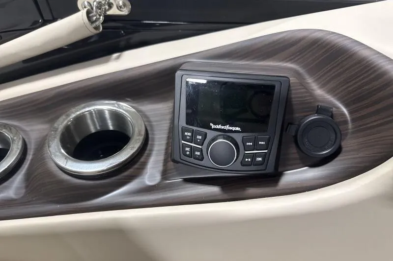 Slide: The Image of 2026 Bennington 25 QXSBWASF boat console with Rockford Fosgate audio system and cup holders. - 11