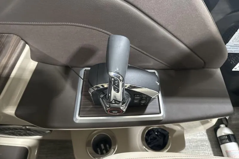 Slide: The Image of Throttle control of 2026 Bennington 25 QXSBWASF boat, featuring sleek design and cup holders. - 17