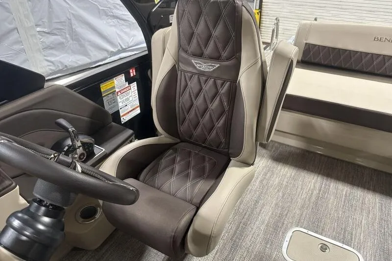Slide: The Image of 2026 Bennington 25 QXSBWASF boat interior with luxurious seating and steering wheel. - 18