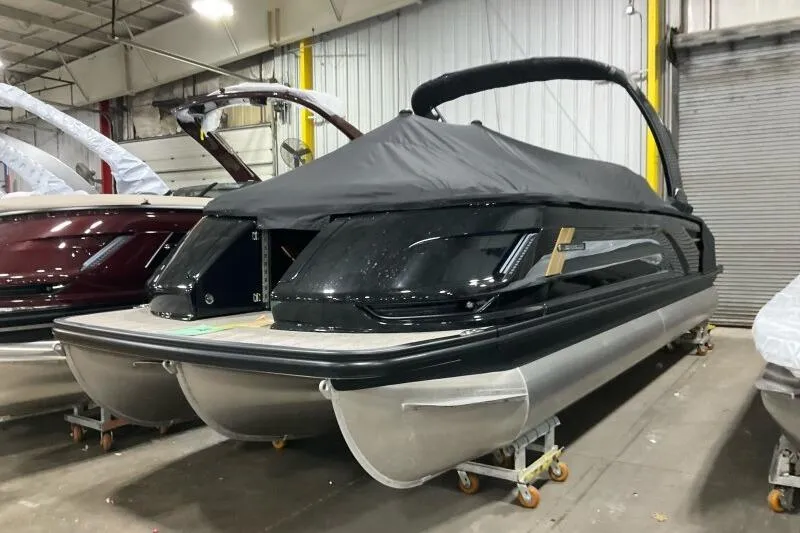 Slide: The Image of 2026 Bennington 25 QXSBWASF pontoon boat in warehouse, covered and ready for transport. - 21