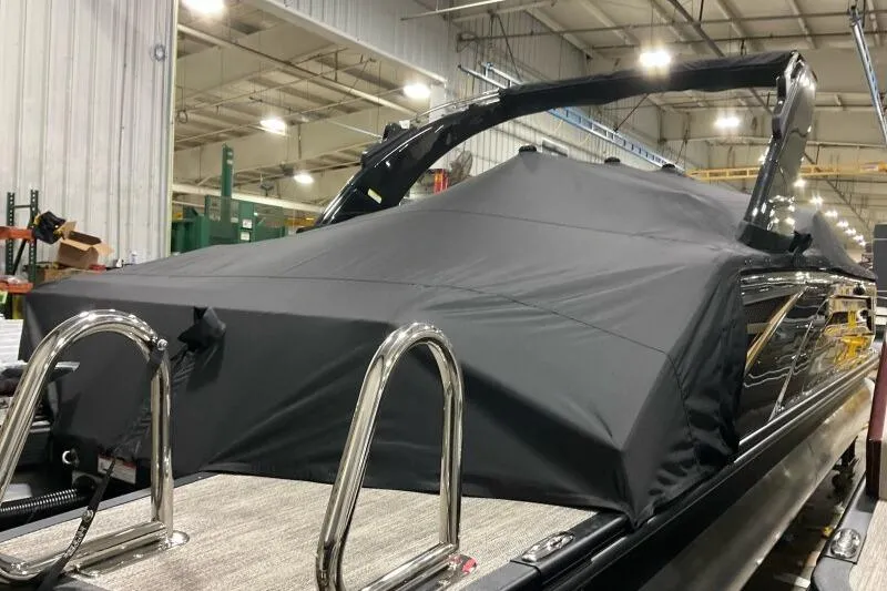 Slide: The Image of 2026 Bennington 25 QXSBWASF boat with cover in a warehouse setting. - 23