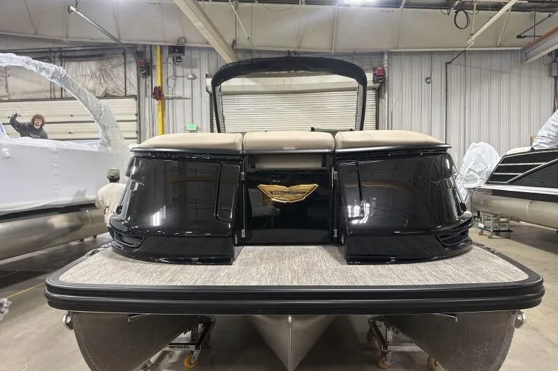 Slide: The Image of 2026 Bennington 25 QXSBWASF pontoon boat in a showroom, rear view. - 3