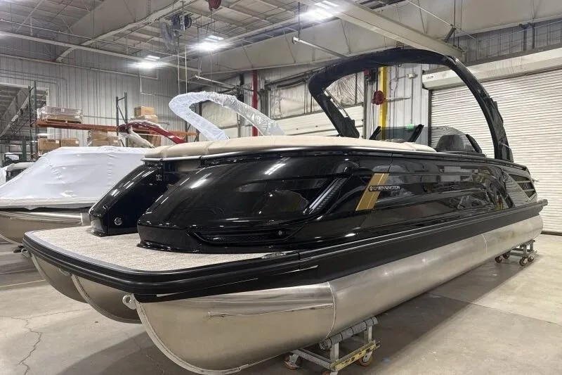 Slide: The Image of 2026 Bennington 25 QXSBWASF pontoon boat in a warehouse setting. - 4