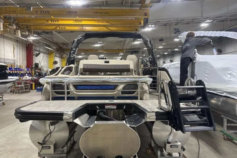 Slide: The Image of 2026 Bennington 25 QXSBWASF pontoon boat in a manufacturing facility. - 7