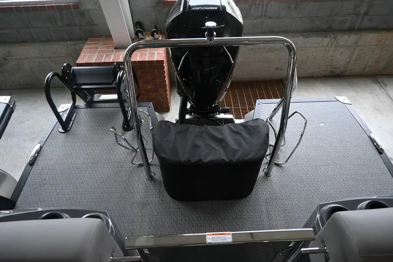 Slide: The Image of 2026 Evotti 723QL boat deck with motor, railing, and seating in a garage setting. - 11