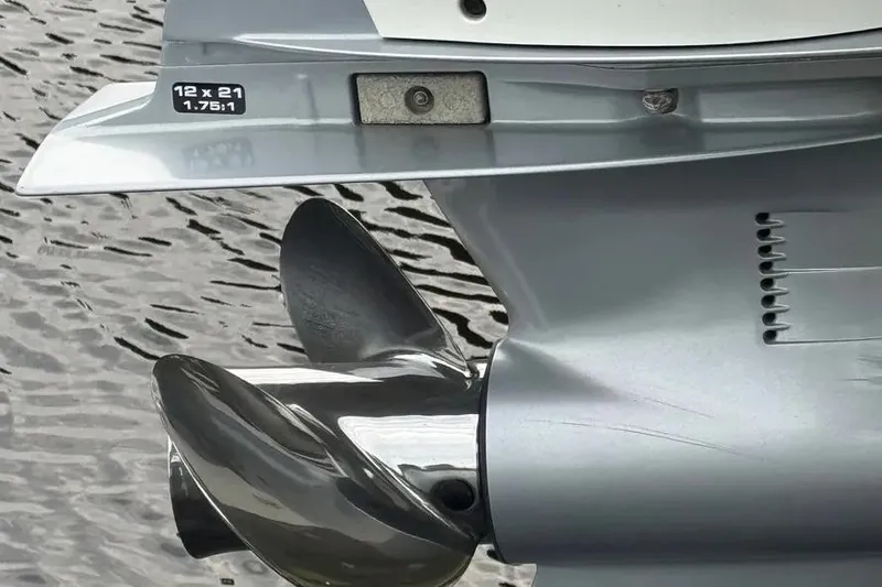 Slide: The Image of Close-up of a 2022 Boston Boatworks Vantage 240 propeller in water. - 12