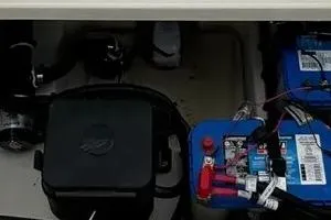 Slide: The Image of 2022 Boston Boatworks Vantage 240 battery compartment with wiring and components. - 13