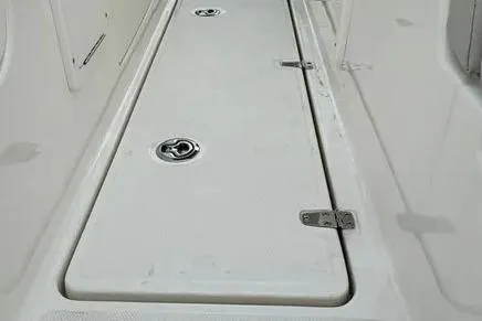 Slide: The Image of 2022 Boston Boatworks Vantage 240 deck with storage compartment. - 14