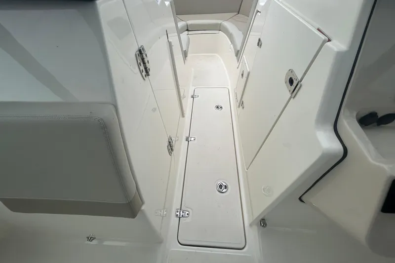 Slide: The Image of 2022 Boston Whaler 240 Vantage interior, showcasing storage compartments and seating area. - 20