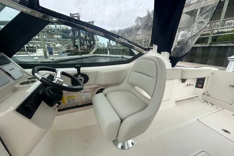 Slide: The Image of Interior view of 2022 Boston Whaler 240 Vantage boat cockpit with steering wheel and seat. - 26