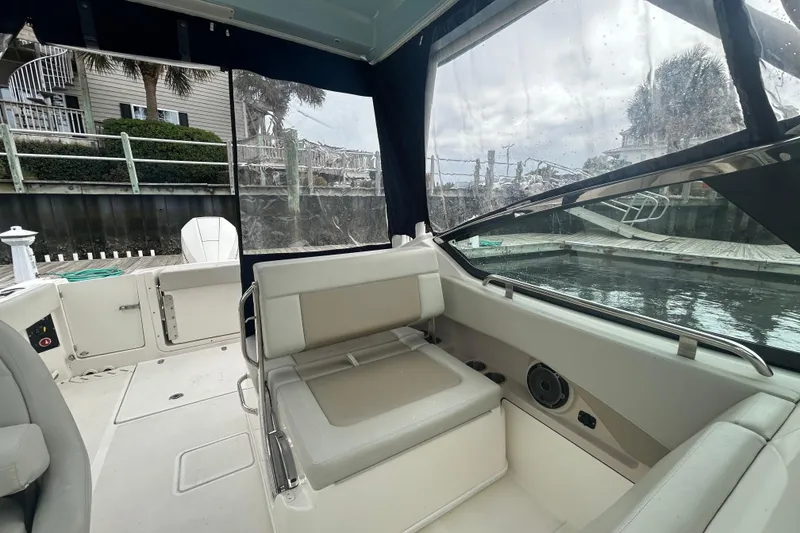Slide: The Image of Interior view of a 2022 Boston Whaler 240 Vantage boat docked by the water. - 27