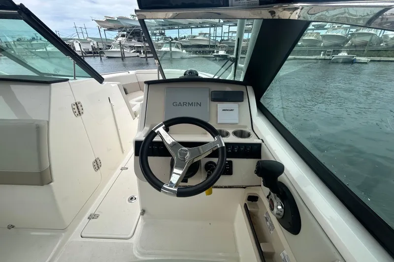 Slide: The Image of 2022 Boston Whaler 240 Vantage helm with Garmin navigation, docked at marina. - 28