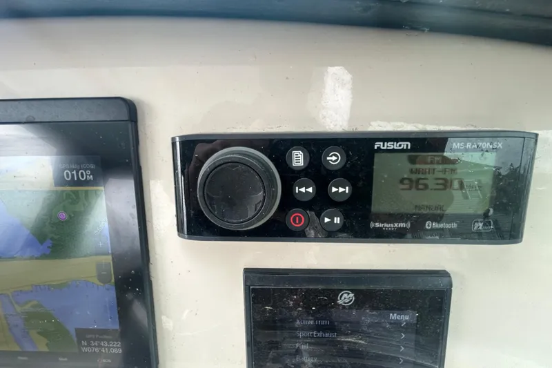 Slide: The Image of Control panel of a 2022 Boston Whaler 240 Vantage boat with GPS and radio display. - 31