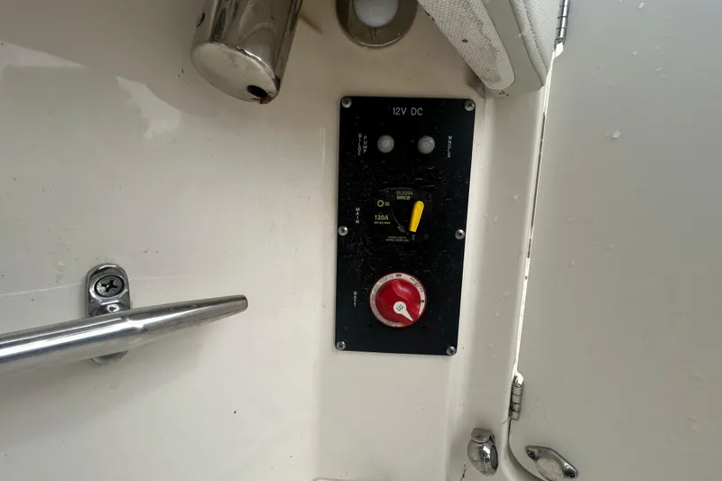 Slide: The Image of Control panel on a 2022 Boston Whaler 240 Vantage boat, featuring 12V DC switches. - 33