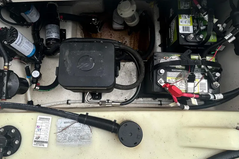 Slide: The Image of 2022 Boston Whaler 240 Vantage boat battery compartment with wiring and components. - 35