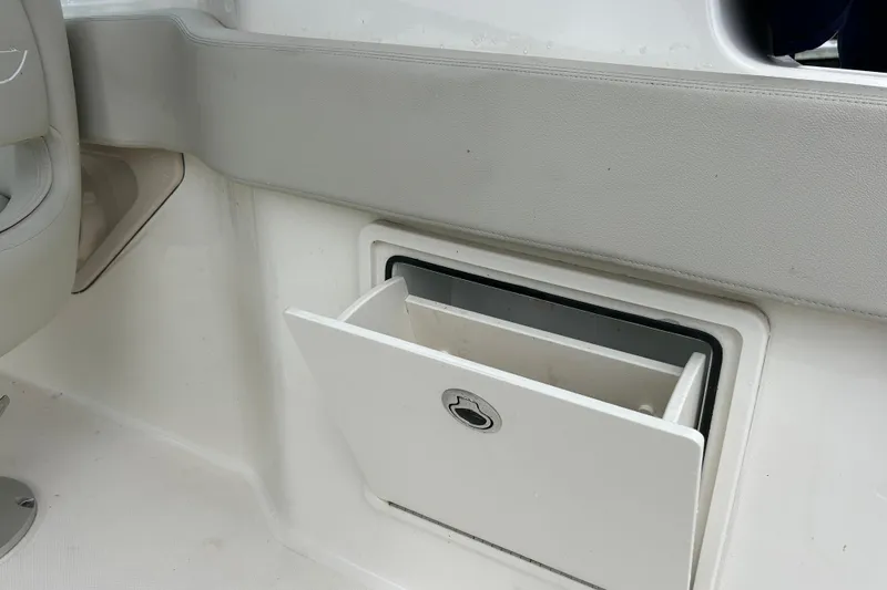 Slide: The Image of 2022 Boston Whaler 240 Vantage storage compartment with open hatch. - 36