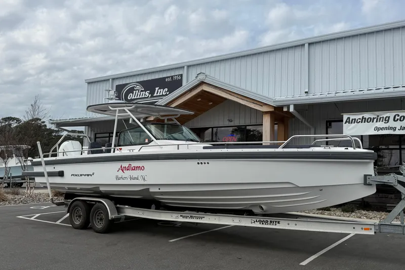 Slide: The Image of 2021 Axopar 28 T-Top boat on trailer outside Collins Inc. building. - 1
