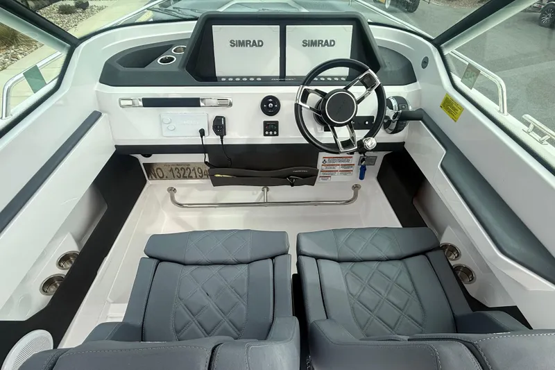 Slide: The Image of 2021 Axopar 28 T-Top boat cockpit with Simrad navigation system and luxurious seating. - 3