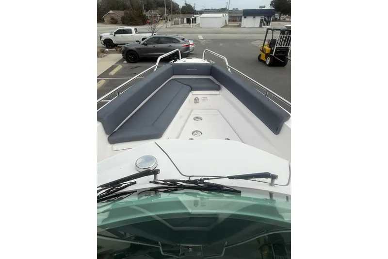 Slide: The Image of 2021 Axopar 28 T-Top boat with spacious seating and sleek design. - 6