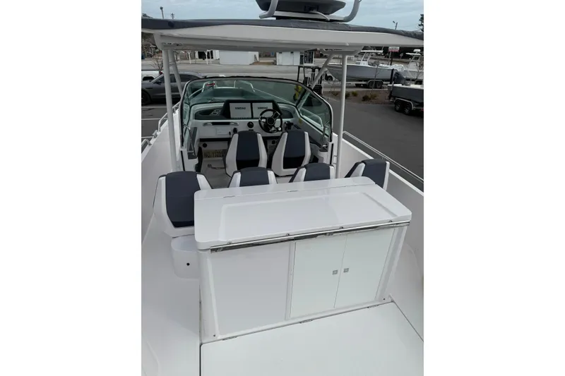 Slide: The Image of 2021 Axopar 28 T-Top boat interior with seating and control panel. - 7