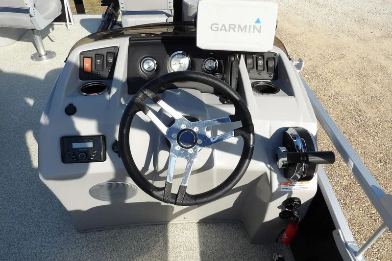 Slide: The Image of 2020 Bennington 20 SFV boat dashboard with Garmin navigation system and steering wheel. - 21
