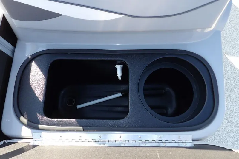 Slide: The Image of 2020 Bennington 20 SFV boat storage compartment with cup holder and drain plug. - 25